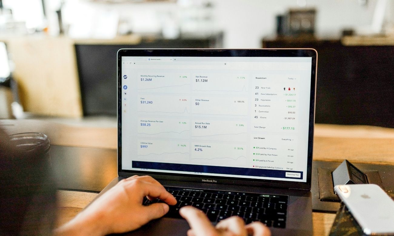 Person looking at metrics on laptop