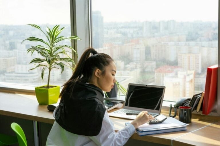 Woman working at desk with laptop