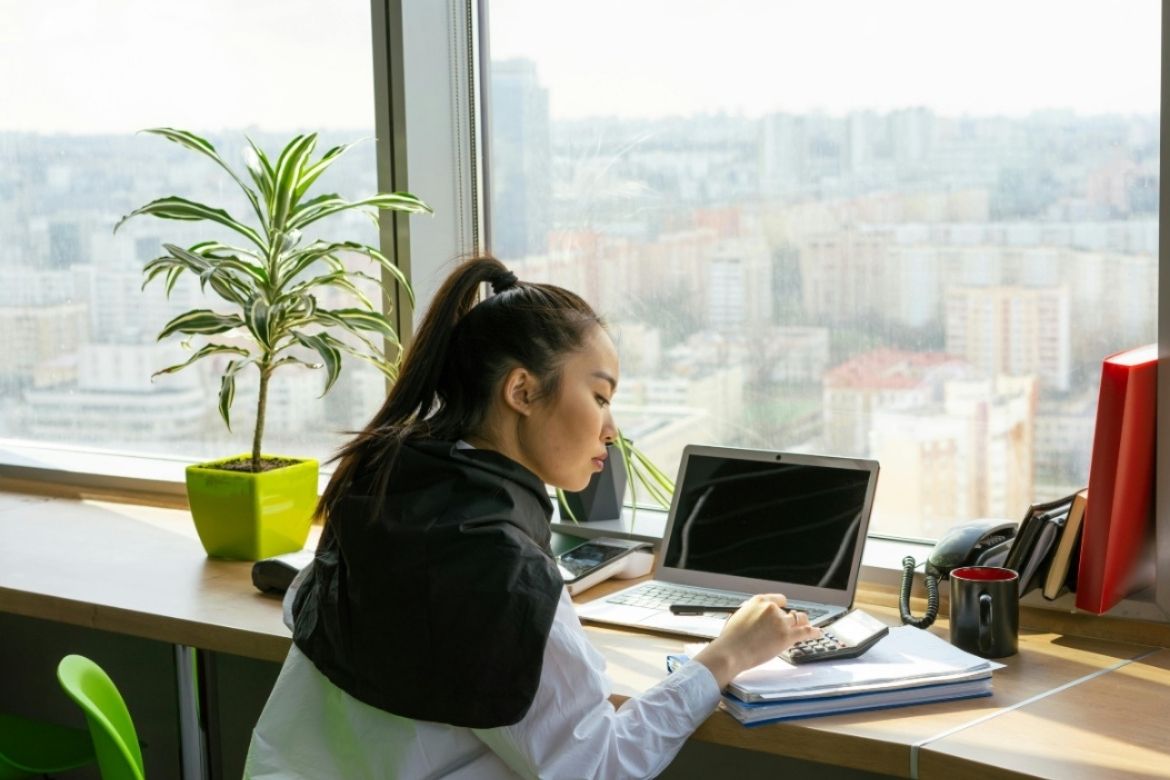 Woman working at desk with laptop