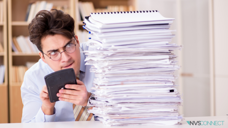 Man with calaculator staring at a stack of papers. NVSConnect logo on bottom right